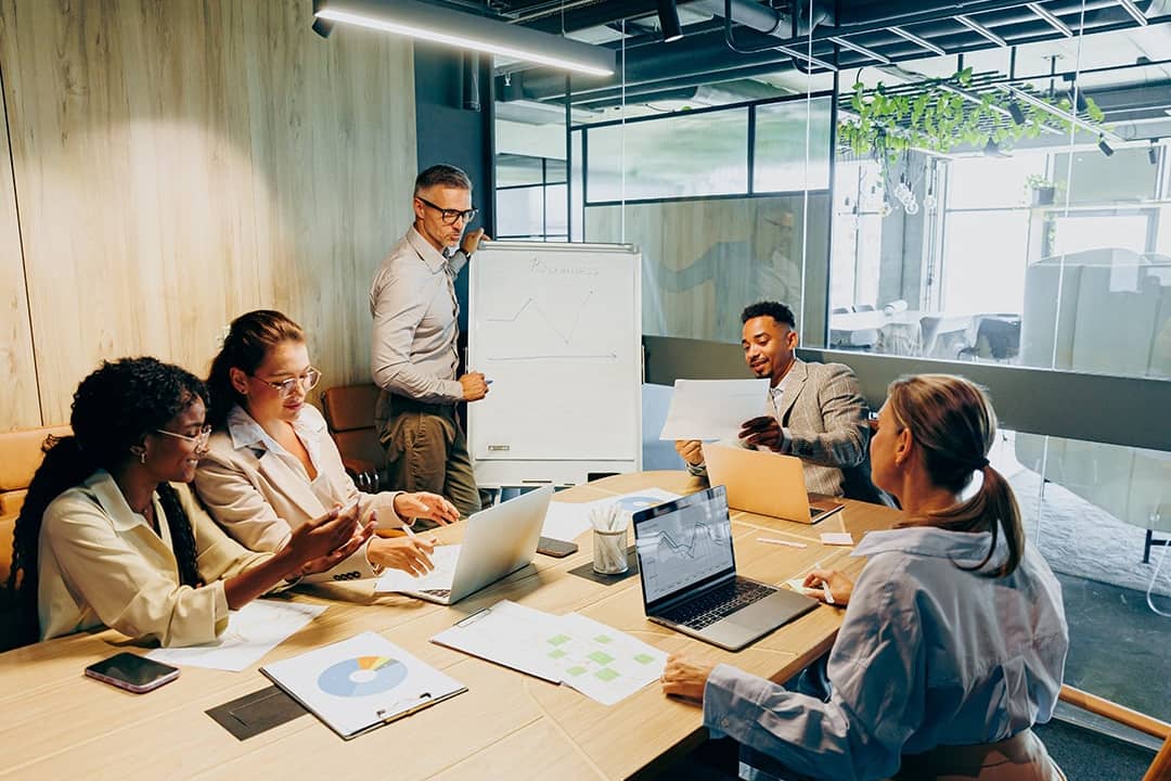 A business team brainstorming and discussing a report.